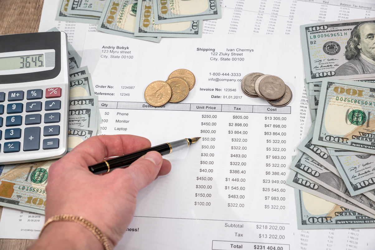 Businessman Counting the Cost of Purchases